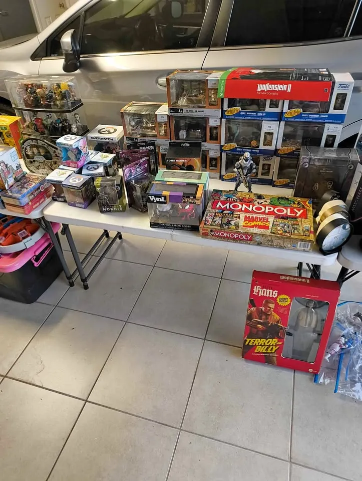 Garage sale in Townsville QLD: toy gel blasters, tin signs and assorted items