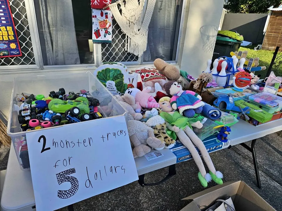 Garage sale in Golden Beach QLD: kids clothes, pillows and toys
